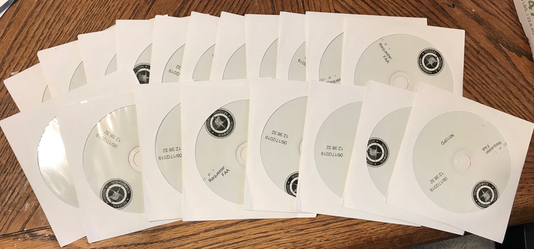 A large number of CD-ROMS in envelopes on a table