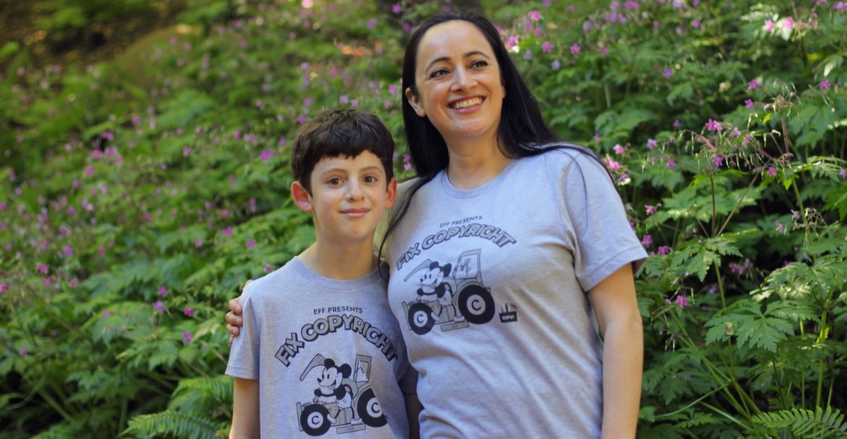 Woman and child wearing EFF's Fix Copyright t-shirt. Grey shirt with Steamboat Willie fixing a tractor Woman and child wearing EFF's Fix Copyright t-shirt. Grey shirt with Steamboat Willie fixing a tractor