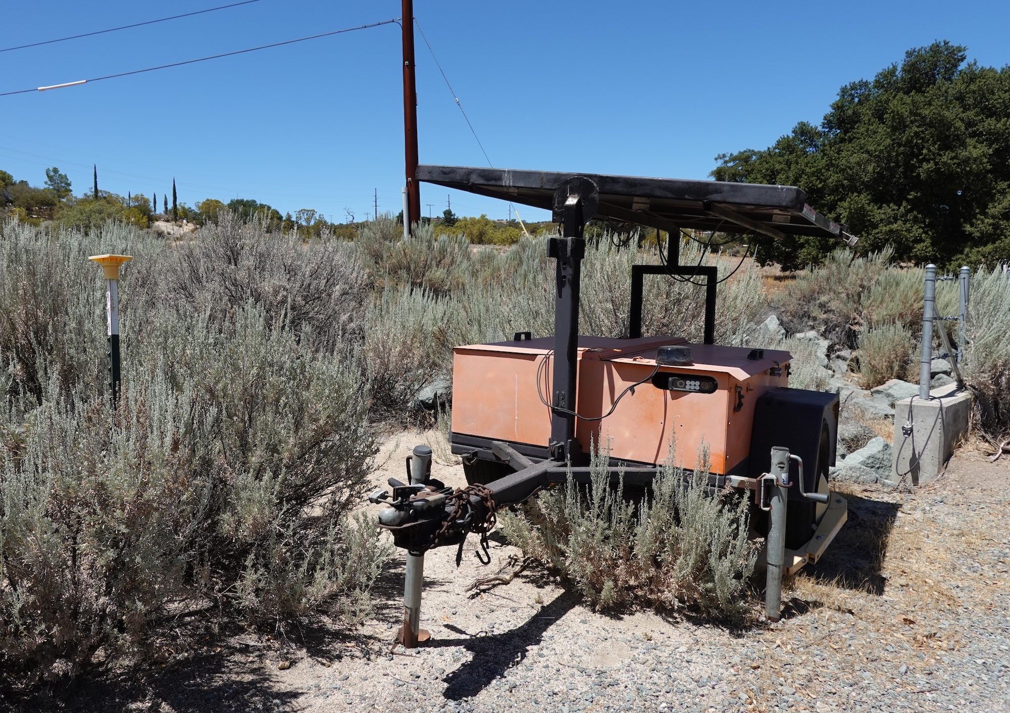 An orange trailer with an ALPR camera and a solar panel.